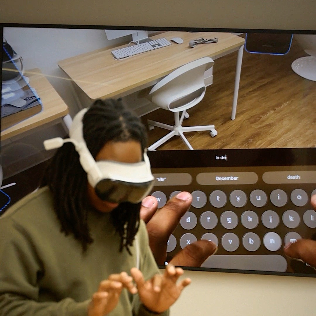 Juan typing on a floating keyboard in Apple Vision Pro.